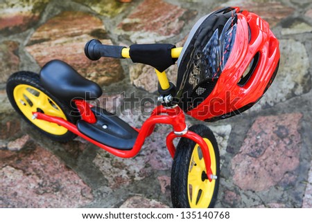 Child bicycle and helmet, for two years children. Selective focus on helmet