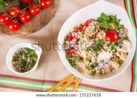 Fresh salad with couscous, pies, tomato, mozarella, onions and fresh mint