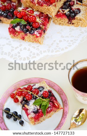 Fresh baked homemade red and black currant berries cake with tea