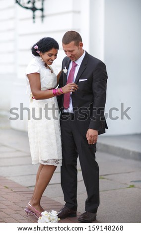 Beautiful indian bride and caucasian groom, after wedding ceremony