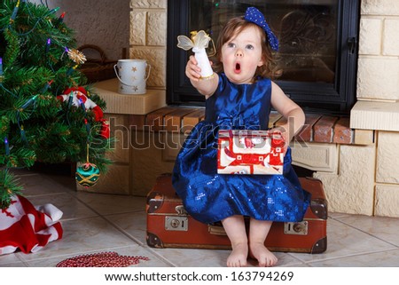 Little girl being happy about christmas present