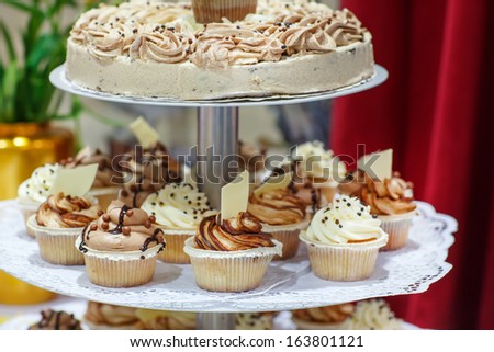 Wedding cake and cupcakes in brown and cream