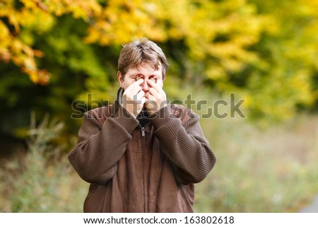 Funny man with chestnuts in autumn forest.