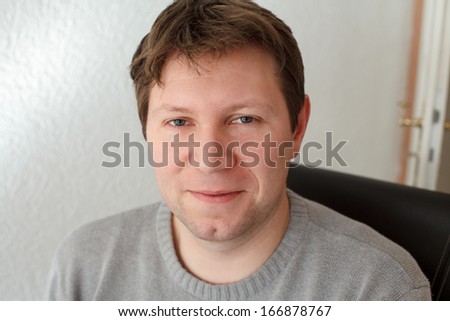 Portrait of beautiful young man smiling indoor
