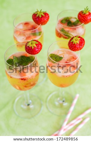Fresh home made summer cocktail with champagne, peppermint and fresh strawberries