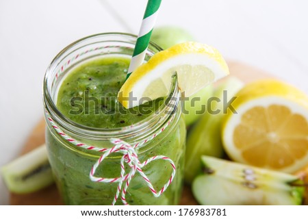 Fresh organic green smoothie with salad, apple, cucumber, pineapple and lemon as healthy drink