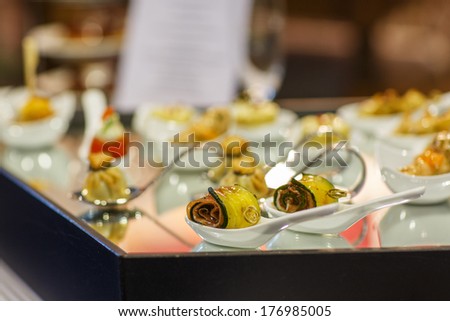 Different tasty snacks as finger food on luxury banquet table .