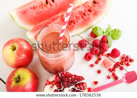 Fresh organic red smoothie with apple, watermelon, pomegranate, raspberry, strawberry as healthy drink