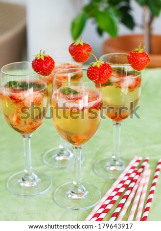 Fresh home made summer cocktail with champagne, peppermint and fresh strawberries