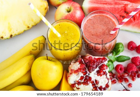 Fresh organic red and yellow smoothie with apple, watermelon, pomegranate, raspberry, pineapple, banana and mango