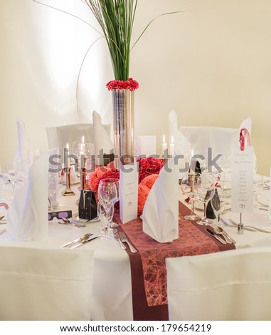 Elegant table set  for wedding or event party in soft red and pink, with paper bride and groom