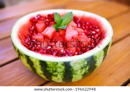 Fresh juicy watermelon decorated with heart pieces and pomegranate