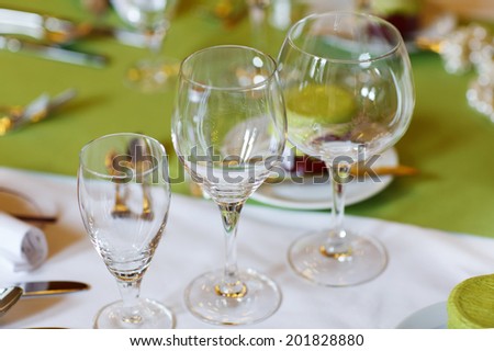 Elegant table set in lilac and green for wedding or event banquet, with give away for guests
