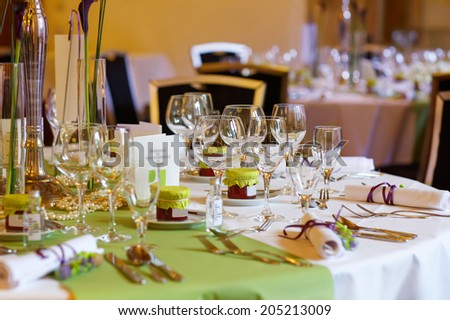 Elegant table set in lilac and green for wedding or event party, with give away for guests