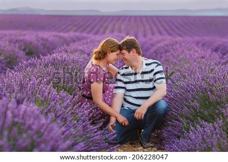 Romantic couple in love in lavender fields, having vacations in Provence, France.