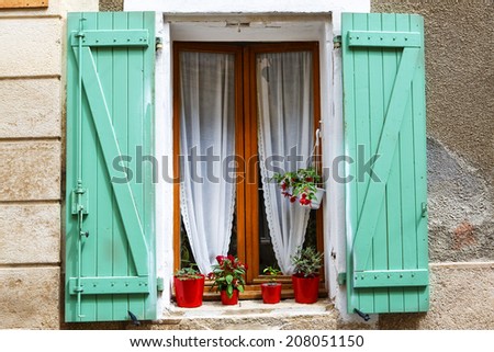 Window with flowers in typical houses in southern France, Provence