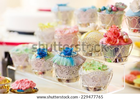 Elegant sweet table with cupcakes and other sweets for dinner or event party