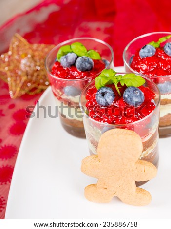 Christmas dessert: Sweet dessert tiramisu with strawberry, fresh blueberry and gingerbread man cookie