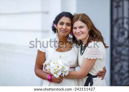 Beautiful happy indian bride and her girl friend as bridesmaid after wedding ceremony. Friendship concept.