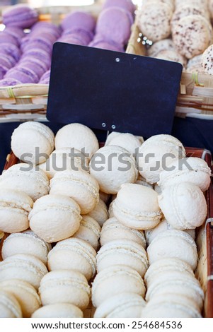 White and purple macarons, traditional sweet food in France on a farmer market in Arles, Provence.
