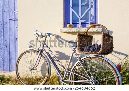 Farmer house near lavender fields near Valensole in Provence, France. With bike, lavender bouquet in basket with typical provencal style.