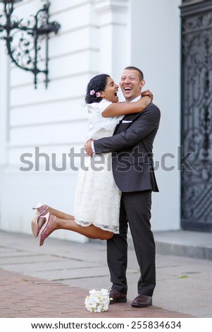 Beautiful indian bride and caucasian groom,  after wedding ceremony. Happy couple in love, celebrating wedding.