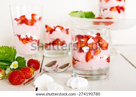 Summer dessert: strawberry with yoghurt cream and meringue in glass. Healthy organic and vegan food.