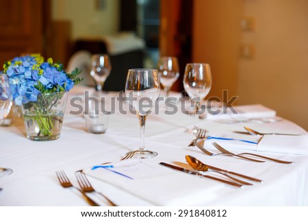 Table set in blue and white for wedding or event party. Luxury decoration for celebration, with give away for guests