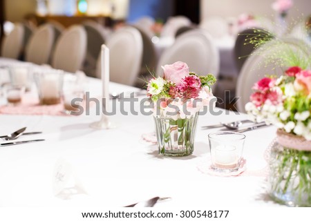 Table set in soft pink and white for wedding or event party. Luxury decoration for celebration, with give away for guests