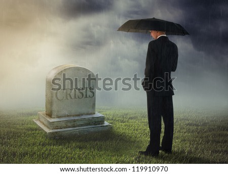 Businessman with umbrella standing near tomb of crisis