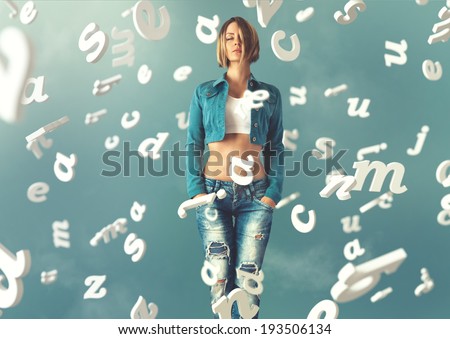 Sexy young woman in a trendy clothes with letters flying arround her