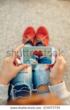 Beautiful young hipster woman using smart phone at beach Beautiful young hipster woman using smart phone at beach