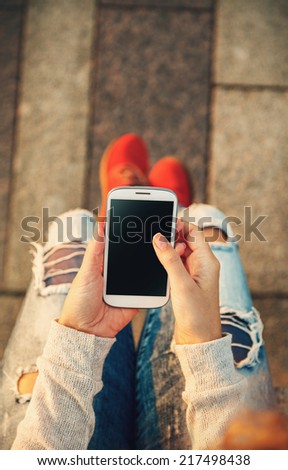 Beautiful young hipster woman using smart phone at beach