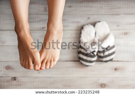 Soft photo of woman\'s feet with slippers, top view point. Cozy, comfy, soft