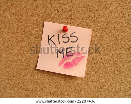 Kiss on orange small sticky note.