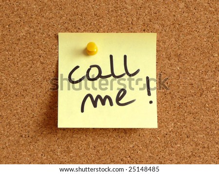 Blue small sticky note on an office cork bulletin board. Call me!