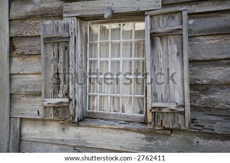 Very old wooden window casement and window with shutters