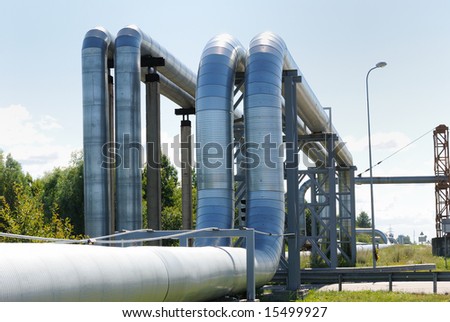 industrial pipelines on pipe-bridge against blue sky.
