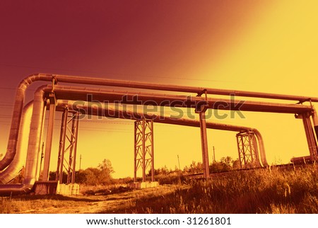 industrial pipelines on pipe-bridge against sky.