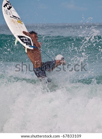 PHUKET THAILAND - NOVEMBER 25 : Unidentified person cuts the wave into half during Quiksilver competition  at Kata Beach Nov 25, 2010 in Phuket.