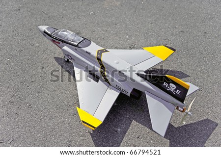 Homemade radio control toy aircraft with electric motor on runway.