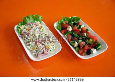 Salads of two kinds on orange background
