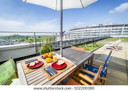 Apartment building roof top terrace exterior with fresh breakfast