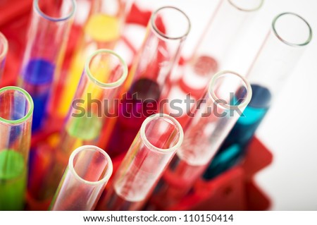 Group of laboratory test tubes with a color reagents in a rack, isolated