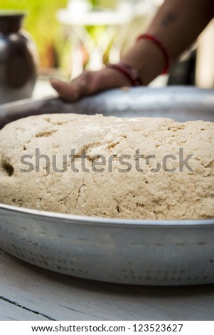 Ready to cook indian naan bread dough in metal bowl