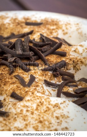 Chocolate flakes on the coffee foam with topped cinnamon
