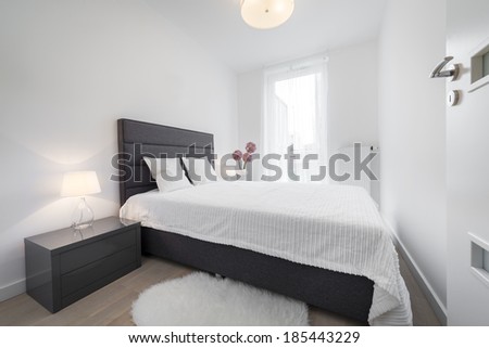 Stylish white bedroom in small room