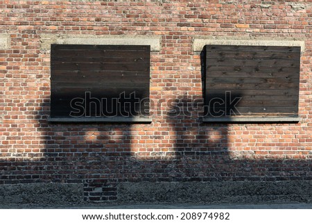 BRZEZINKA, POLAND - OCTOBER 13, 2012: Windows on the wall of house block in concentration camp Auschwitz, Poland. Three million people had died there (2.5 million gassed)