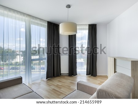 Big windows in modern living room apartment interior design