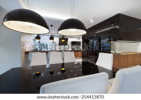 Modern kitchen interior design in black and white style with black table